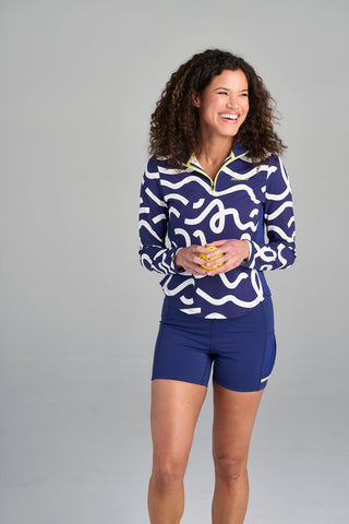 Model is wearing size small in The Brooksie - Rally Print pullover and The Mandy - Midnight bike shorts.