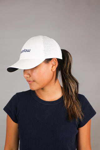 Model is wearing one size White Performance Hat.