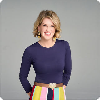 Portrait of Holly Morris Espy, moorlow co-founder, in navy top and patterned skirt—known for brand storytelling, strategy, and purpose-driven pickleball style.
